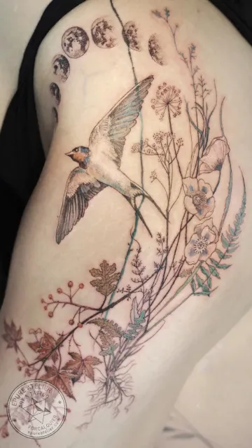 Tatouage hirondelle en vol avec fleurs sauvages et herbes botaniques